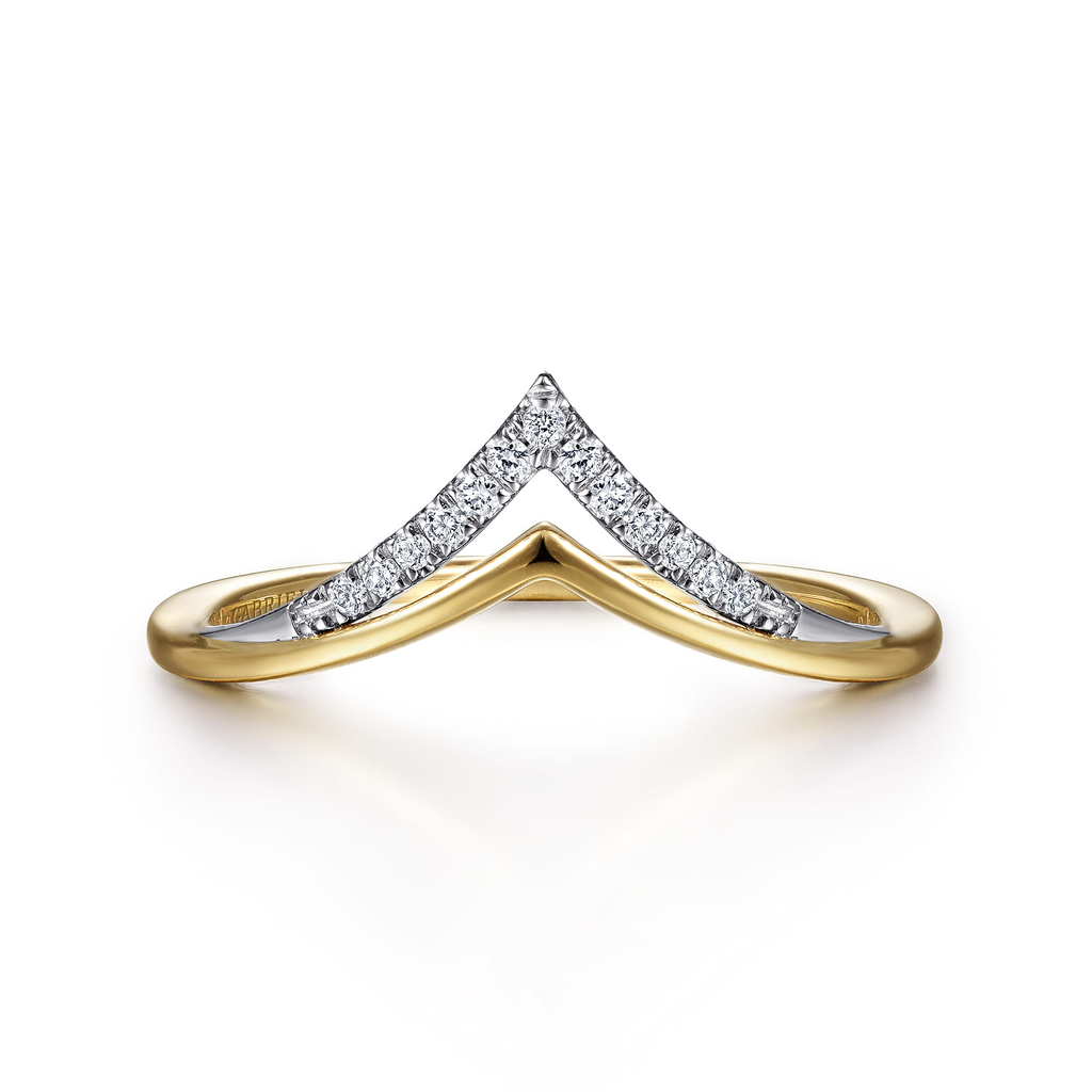 Gold and silver ring with diamond accents on a white background