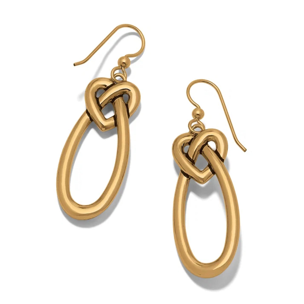 Gold knot earrings on a white background