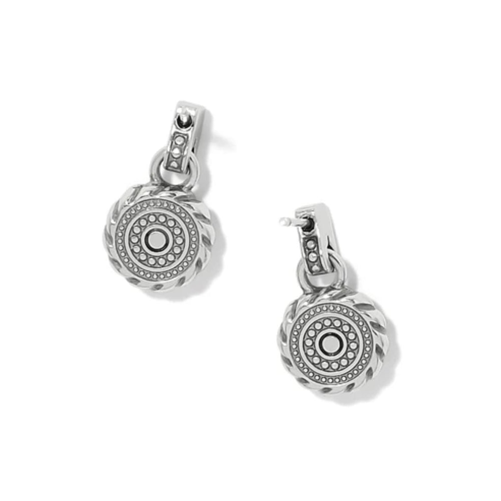 A pair of silver-toned drop earrings with circular medallion charms featuring a textured outer rim, a central round bezel-set stone, and smaller accent stones, shown on a clean white background.