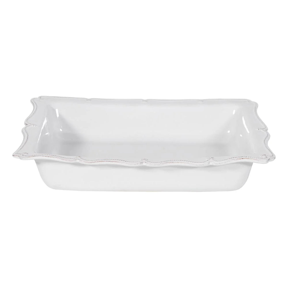 White ceramic dish with ruffled edge on a white background