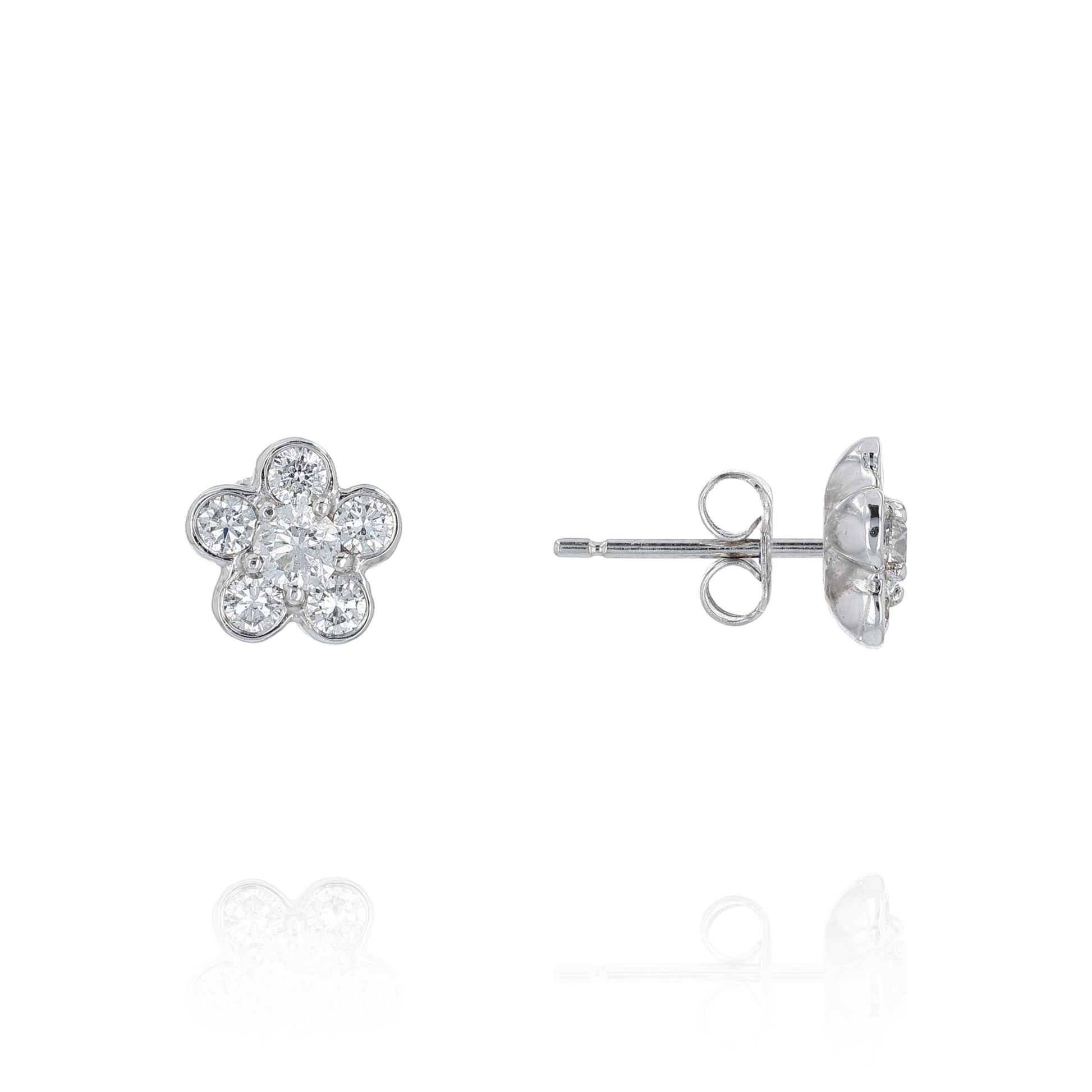 Flower-shaped white gold earrings with diamond accents on a white background