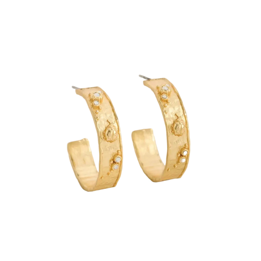 A pair of textured gold hoop earrings with small white pearl-like accents, displayed on a clean white background.