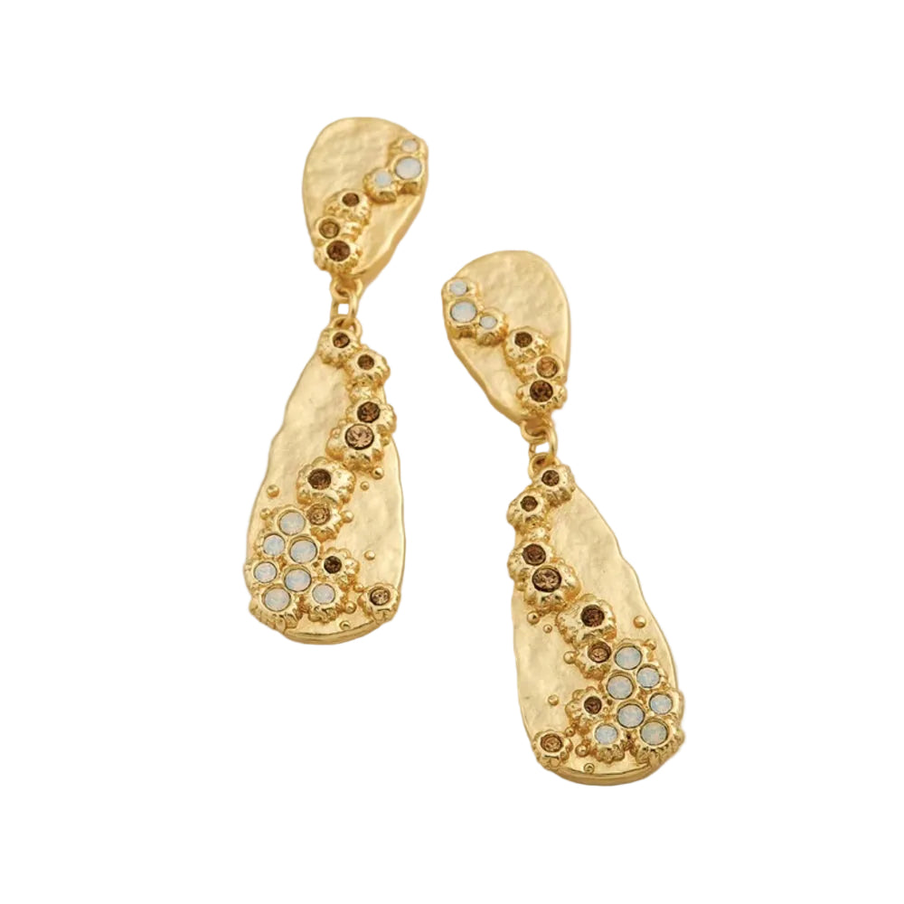 A pair of gold dangle earrings with organic teardrop shapes, featuring textured gold metalwork adorned with small round brown and clear rhinestones, set against a white background.