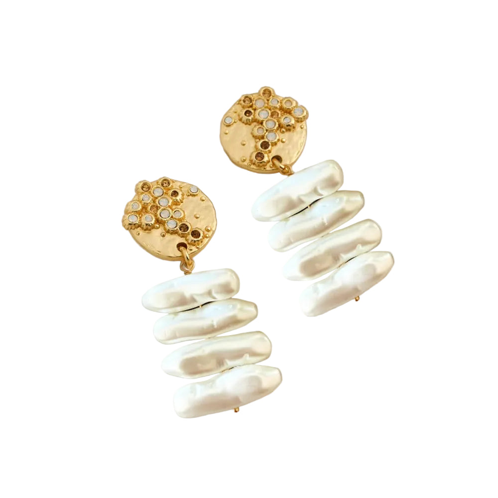 A pair of gold drop earrings featuring textured gold discs with small clear stones and clusters of irregular white baroque pearls hanging below, displayed on a white background.