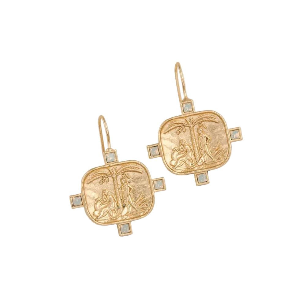 A pair of gold-toned drop earrings with square pendant charms featuring embossed figures and small light blue square accents, shown on a plain off-white background.