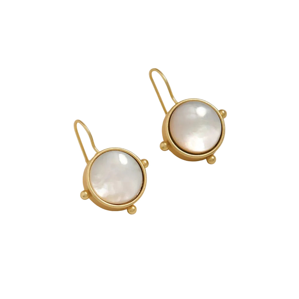 A pair of gold drop earrings with round iridescent white mother-of-pearl bezel settings, displayed on a clean off-white background.