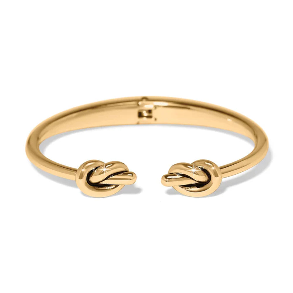 Gold bracelet with knot designs on a white background