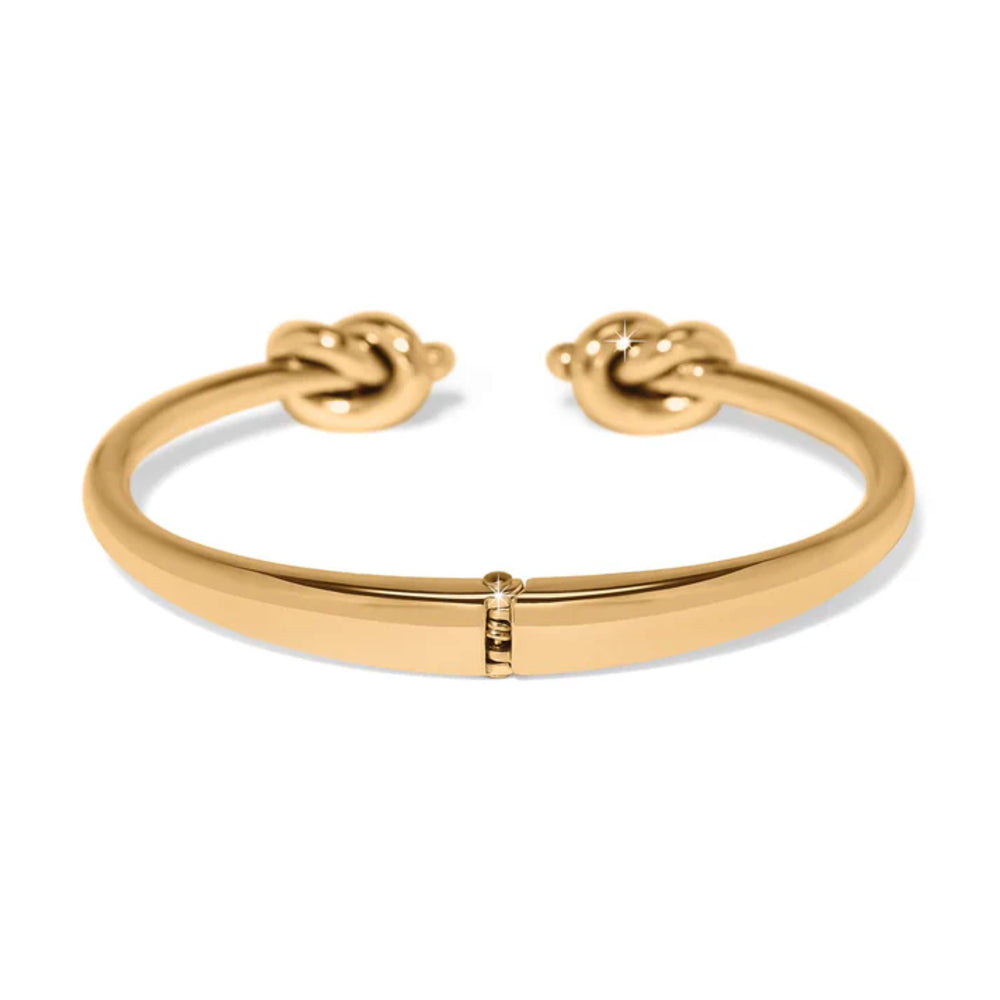 Gold bracelet with knot design on a white background
