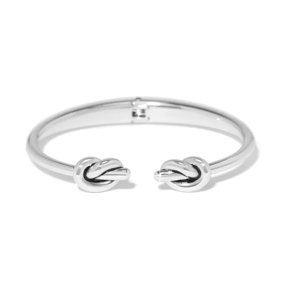 Silver bracelet with knot designs on a white background