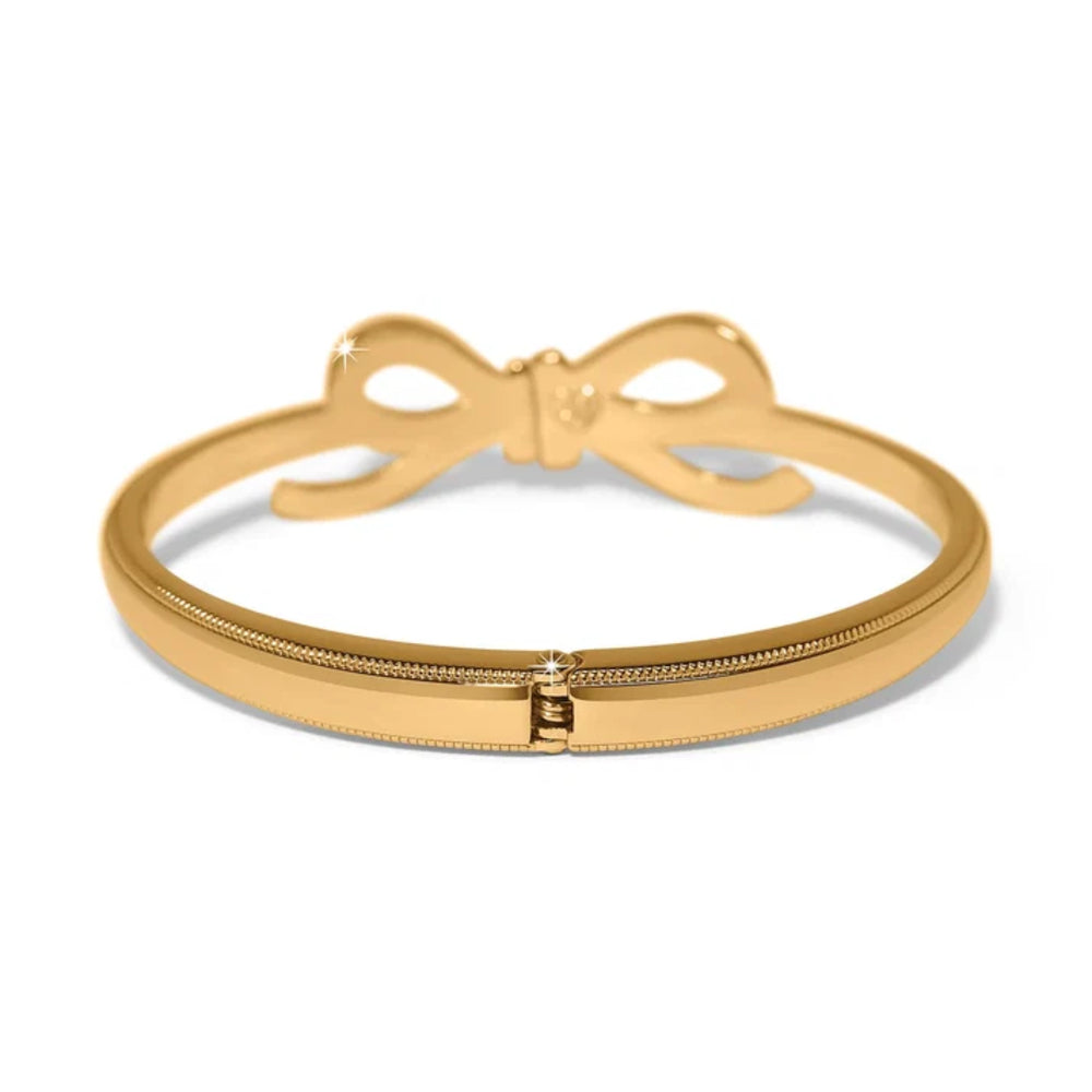 A gold bangle bracelet featuring a bow-shaped clasp and a textured beaded band, shown on a clean white background.