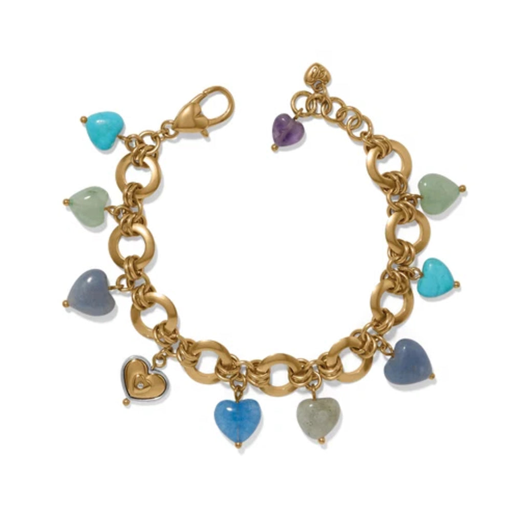 Gold chain bracelet with heart-shaped gemstone charms on a white background