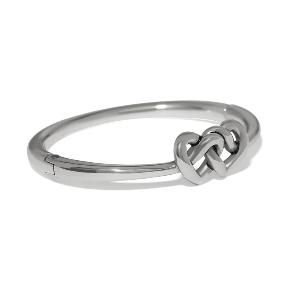Silver bangle with a knot design on a white background