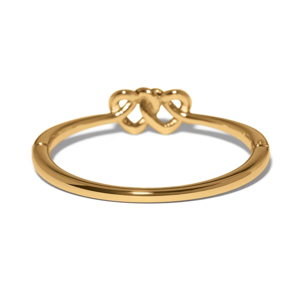 A polished gold-plated metal bracelet with a decorative bow-shaped connector at the top, shown on a clean white background.