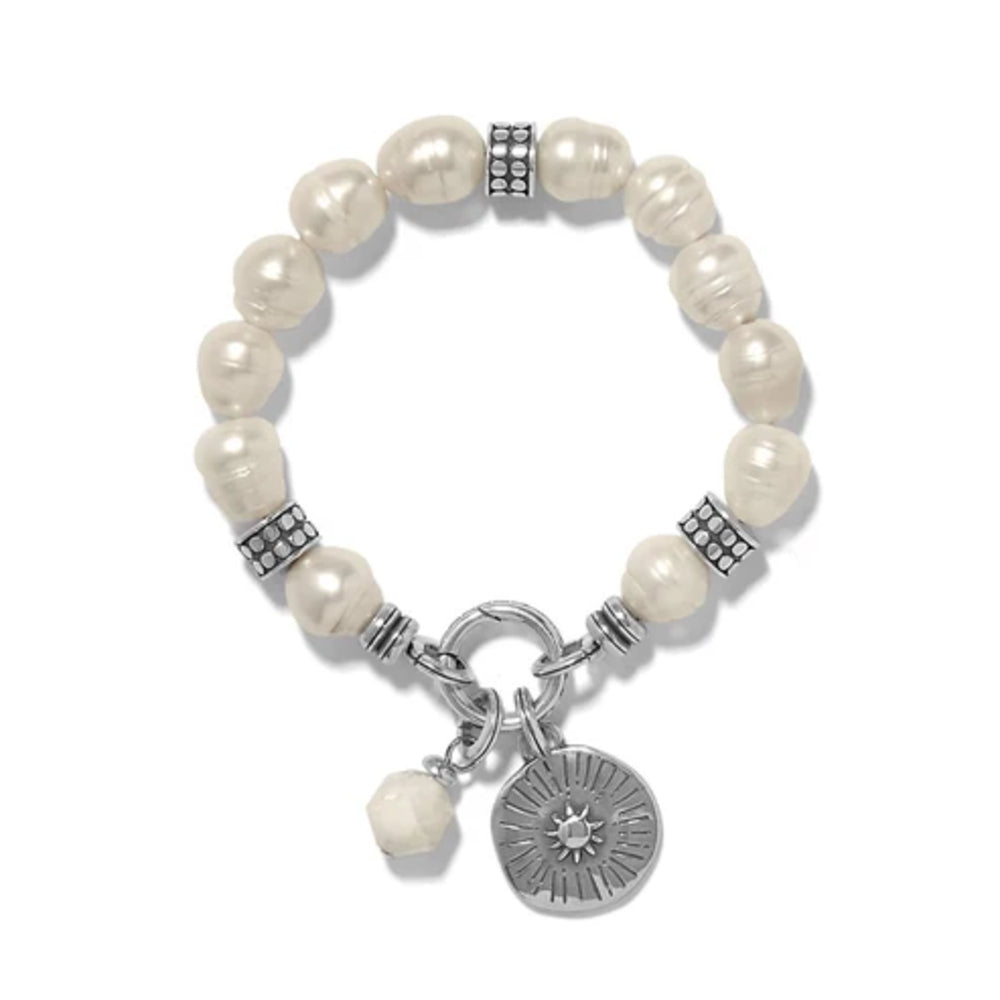 Pearl bracelet with silver charms on a white background