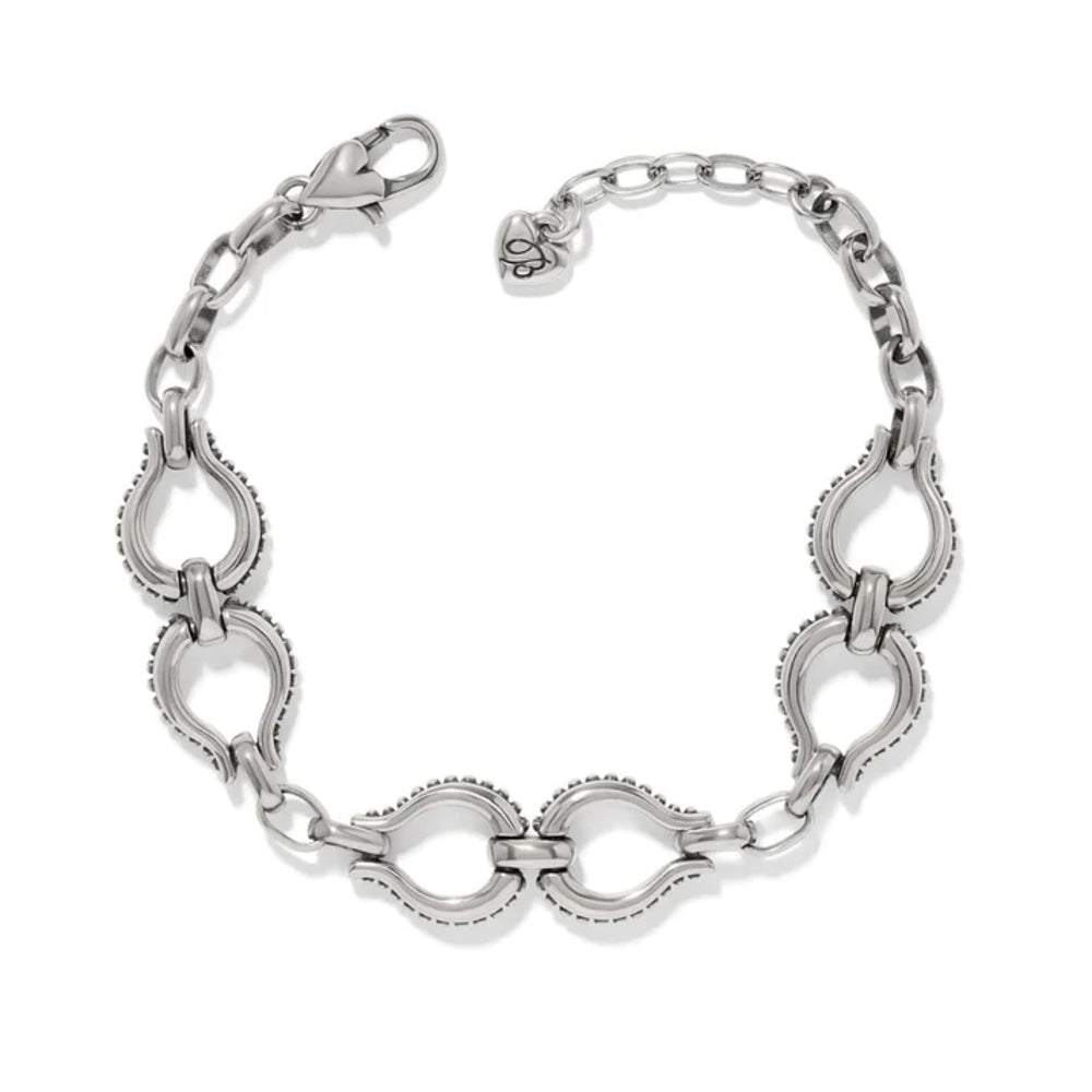 A silver-toned metal bracelet featuring a series of interlocking open teardrop links with beaded edges, a lobster clasp, and an extender chain with a small heart-shaped tag, shown on a plain white background.