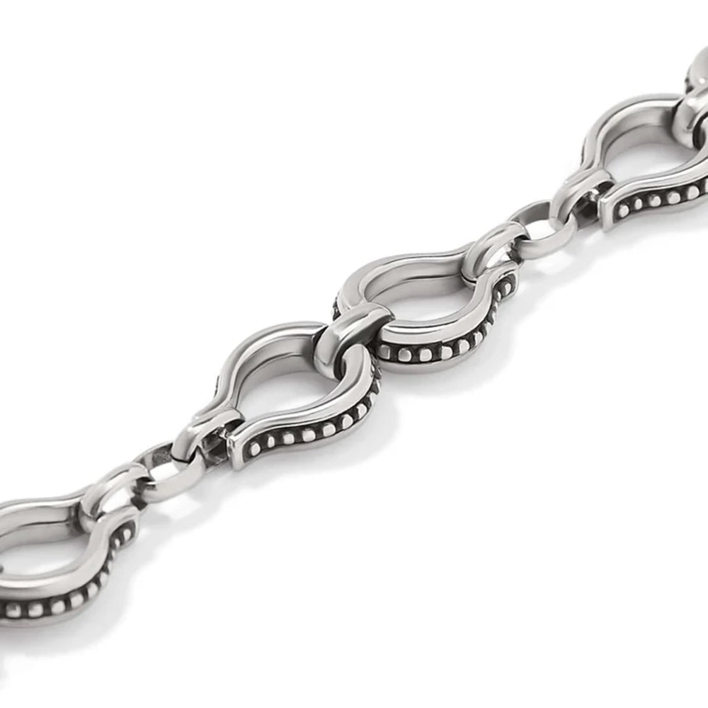 A close-up of a silver-toned metal link chain bracelet with decorative beaded edges and polished oval links, shown on a clean white background.