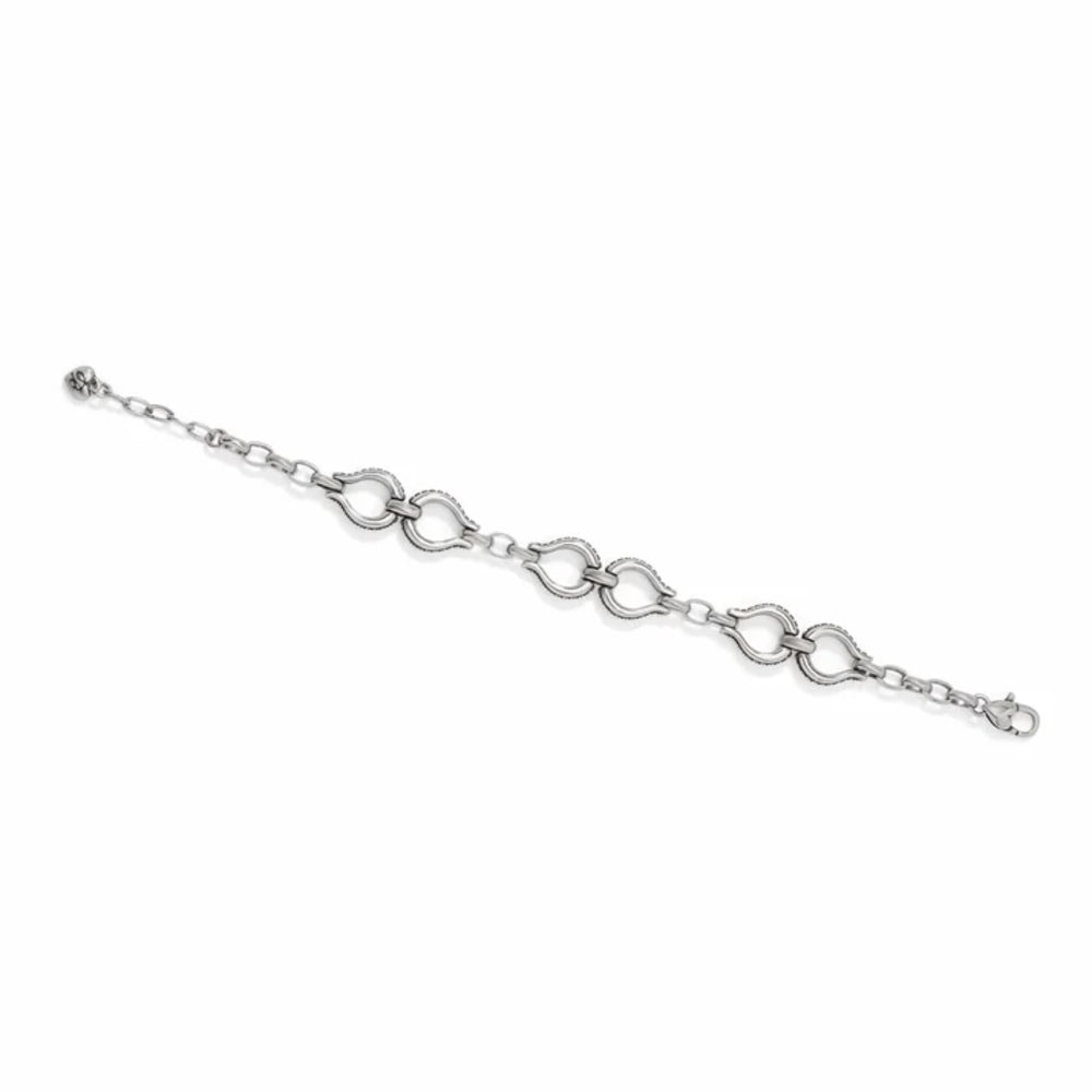 A black automotive shock absorber with a silver metal bracket and black rubber mount, photographed on a clean white background.