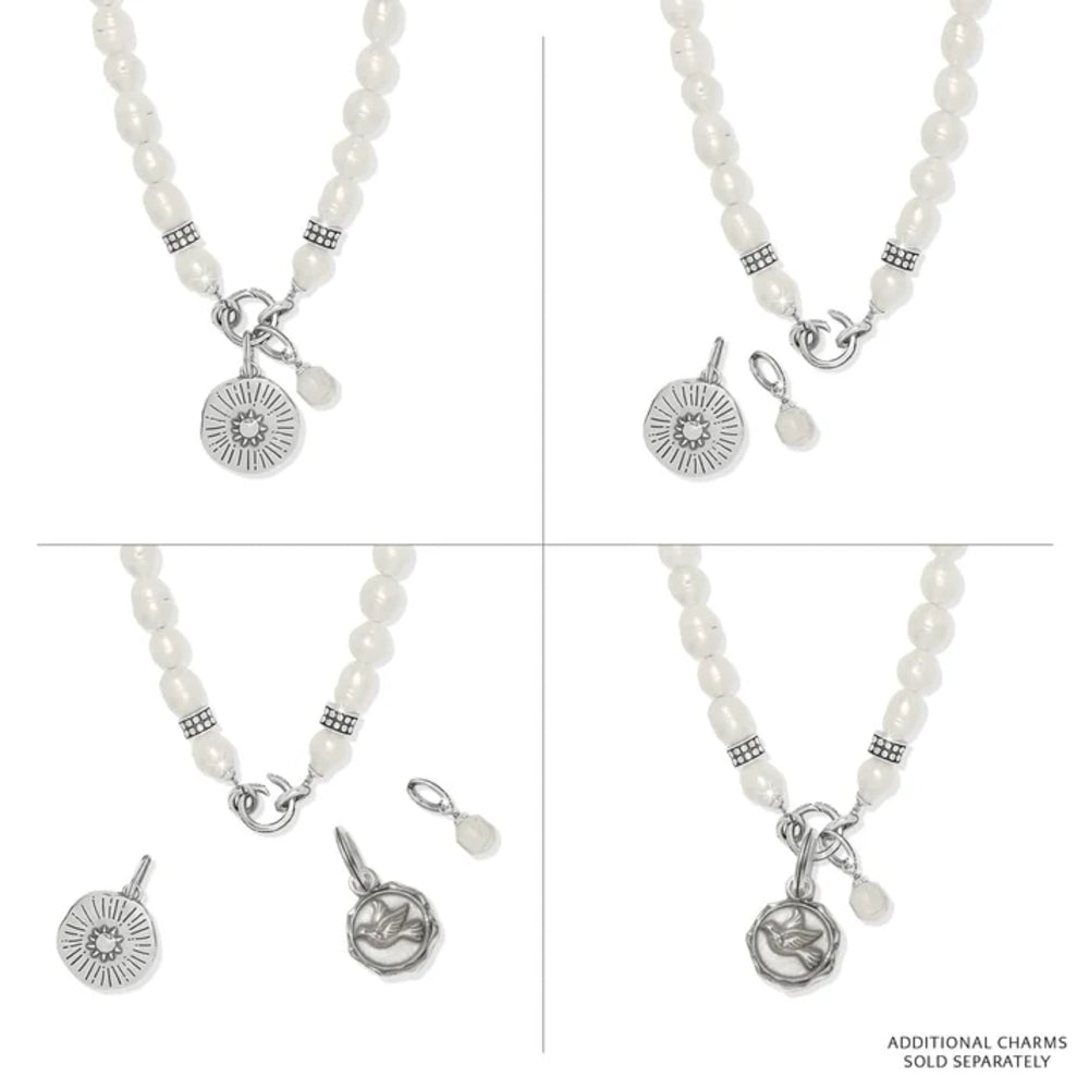 Pearl necklace with silver charms on a white background