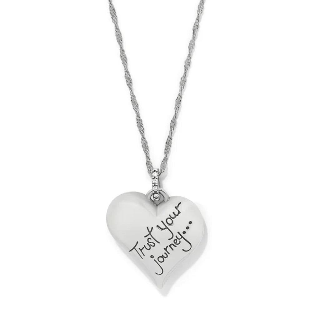 Heart-shaped pendant necklace with 'Trust your journey' text on a white background