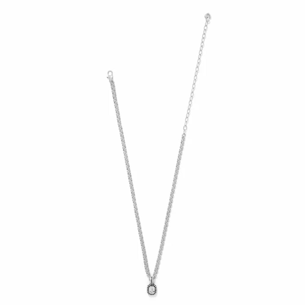 Silver necklace with a small round pendant on a white background