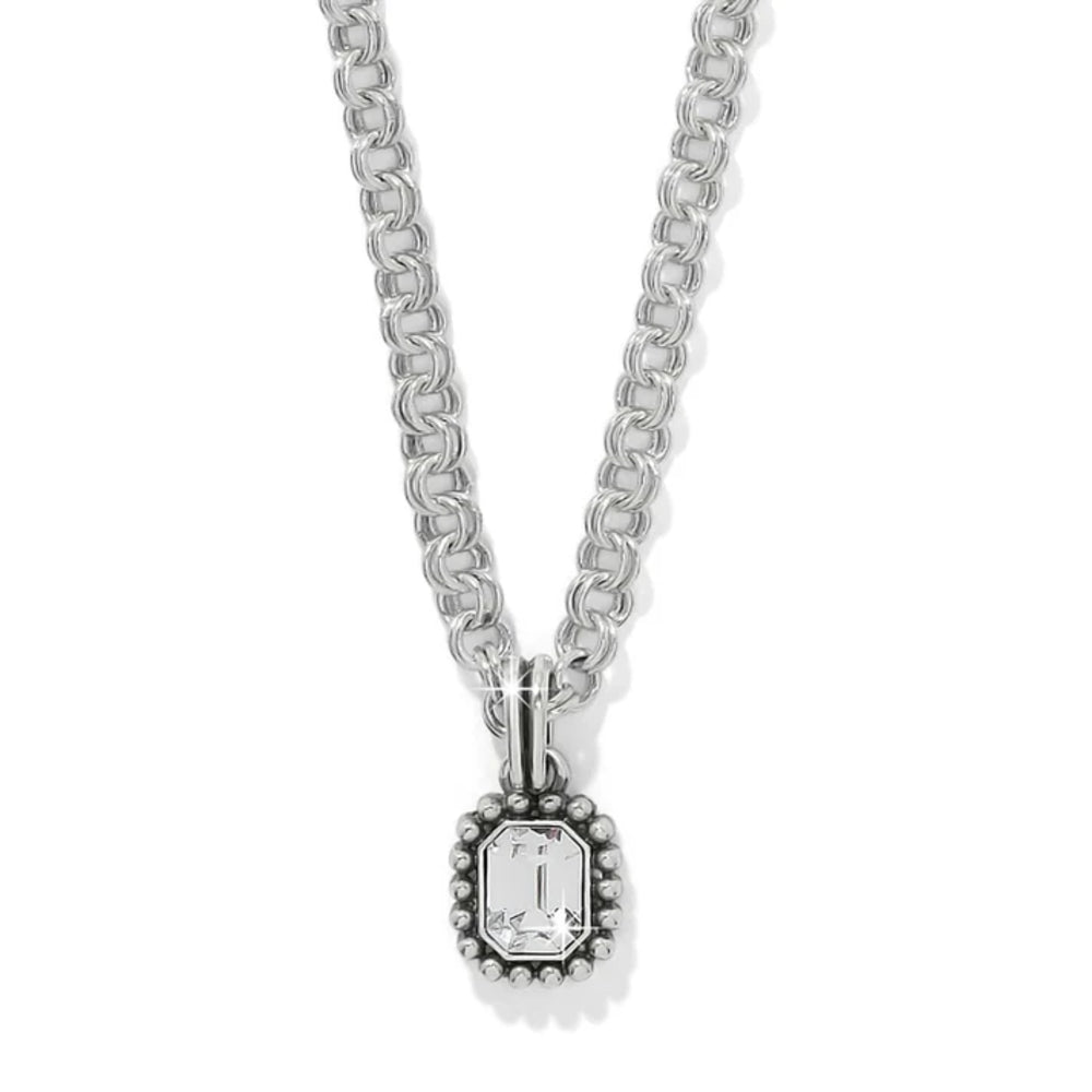A silver-toned necklace featuring a textured chain and a beaded pendant with an emerald-cut clear gemstone, shown against a plain white background.