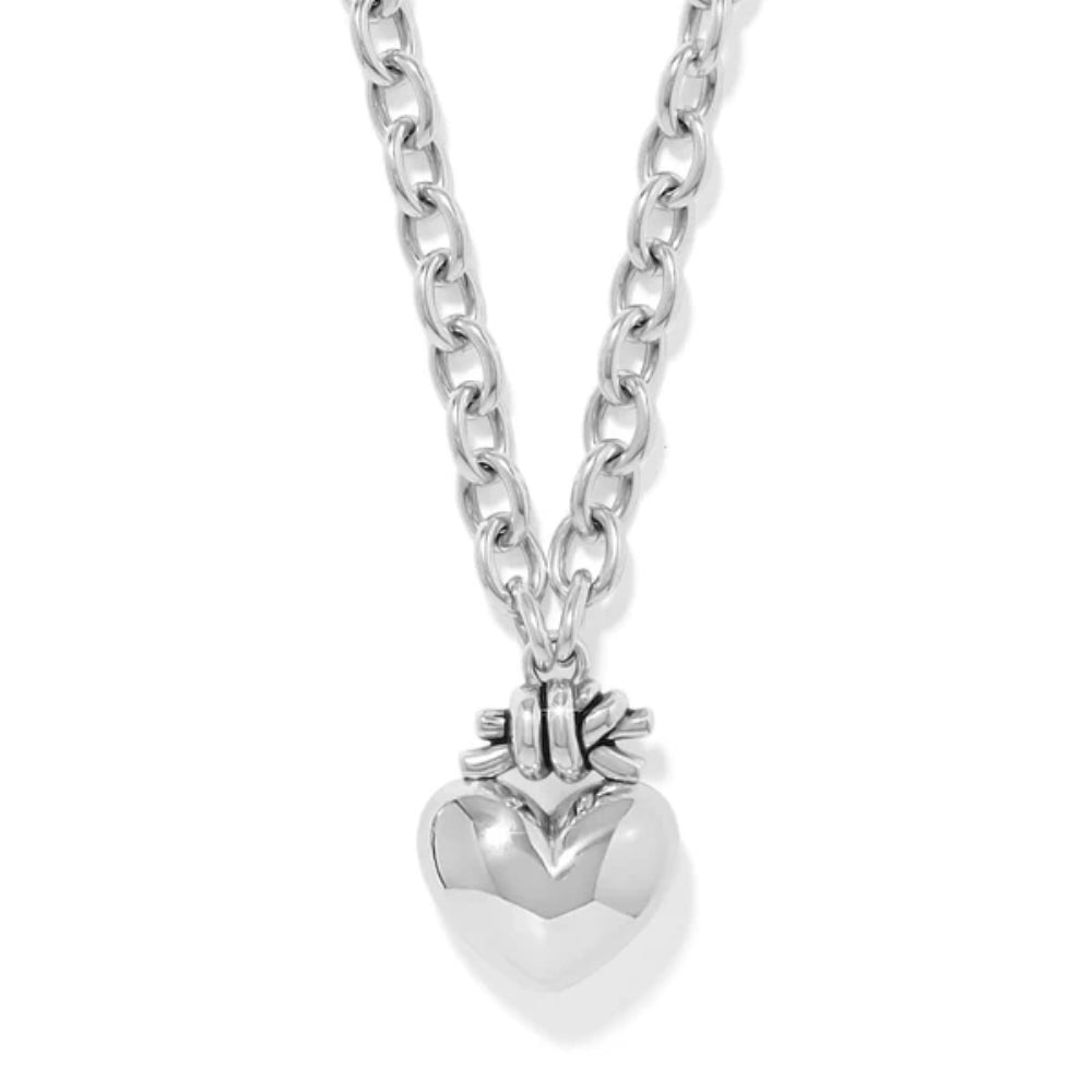 Silver heart-shaped pendant on a chain against a white background