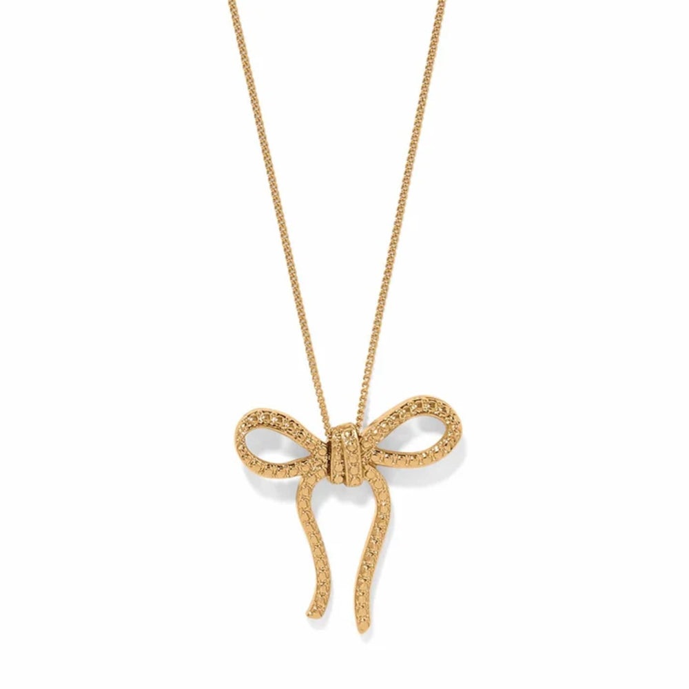 Gold bow-shaped pendant on a chain against a white background