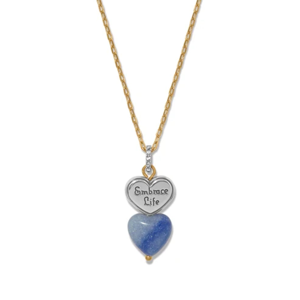 A gold chain necklace with a double-heart pendant. The top heart is silver-toned with the engraved words 'Embrace Life' and is attached to a small clear stone.