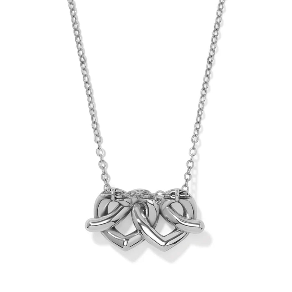 A silver necklace featuring a pendant made of two interlocking hearts on a delicate cable chain, shown against a plain white background.