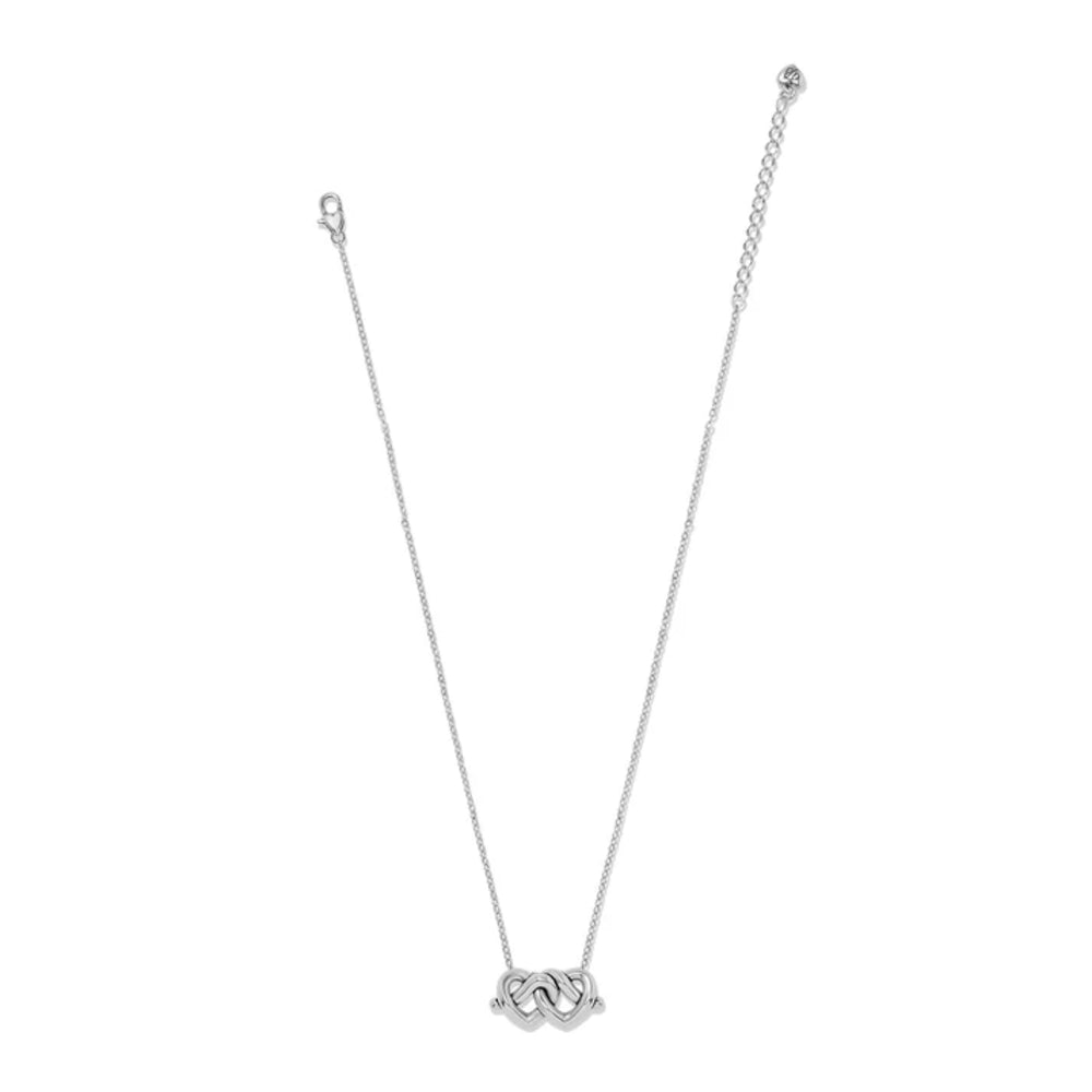 A delicate silver chain necklace featuring a small two interlocking heart pendant, displayed against a solid white background.