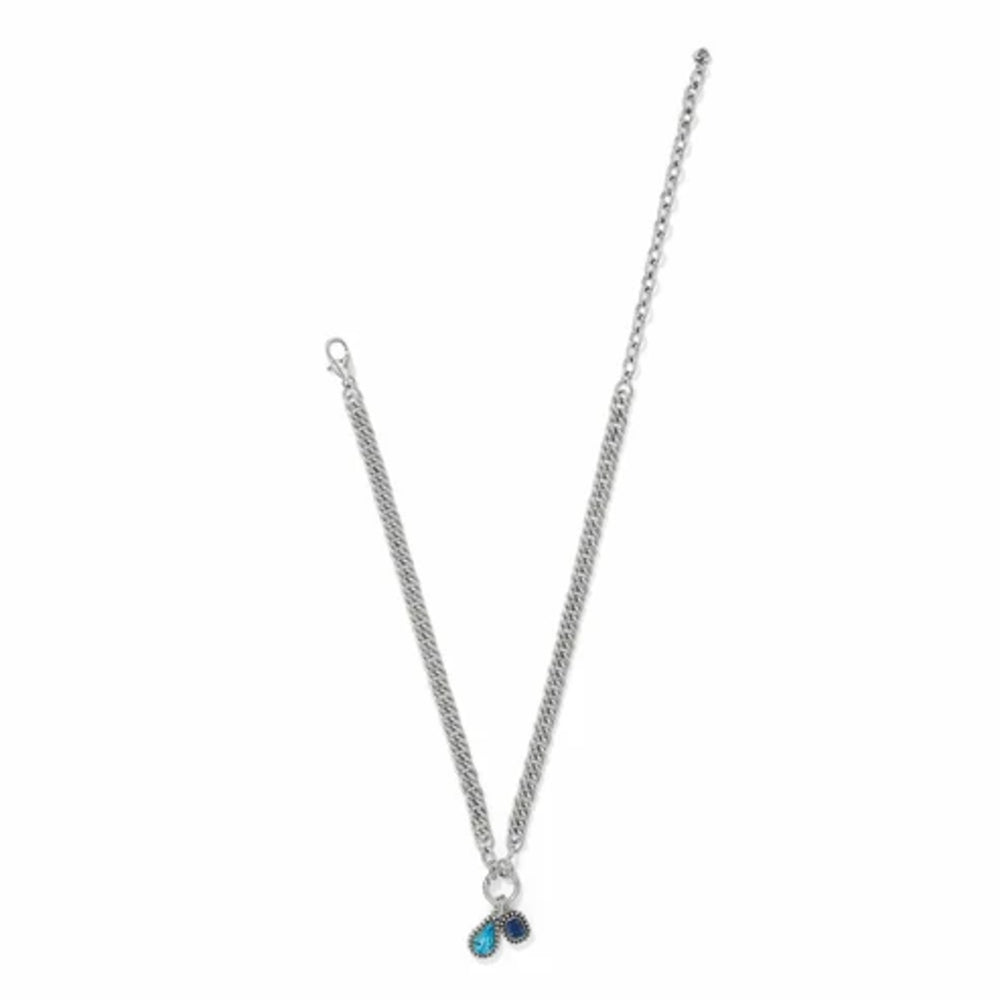 A silver-toned chain necklace with a small double-heart pendant featuring one light blue heart and one dark blue heart, displayed on a clean white background.