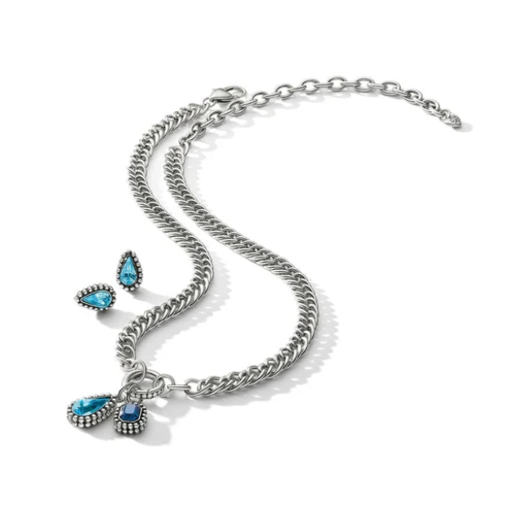 A silver-toned chain necklace with three teardrop-shaped blue gemstone pendants, displayed on a clean white background.