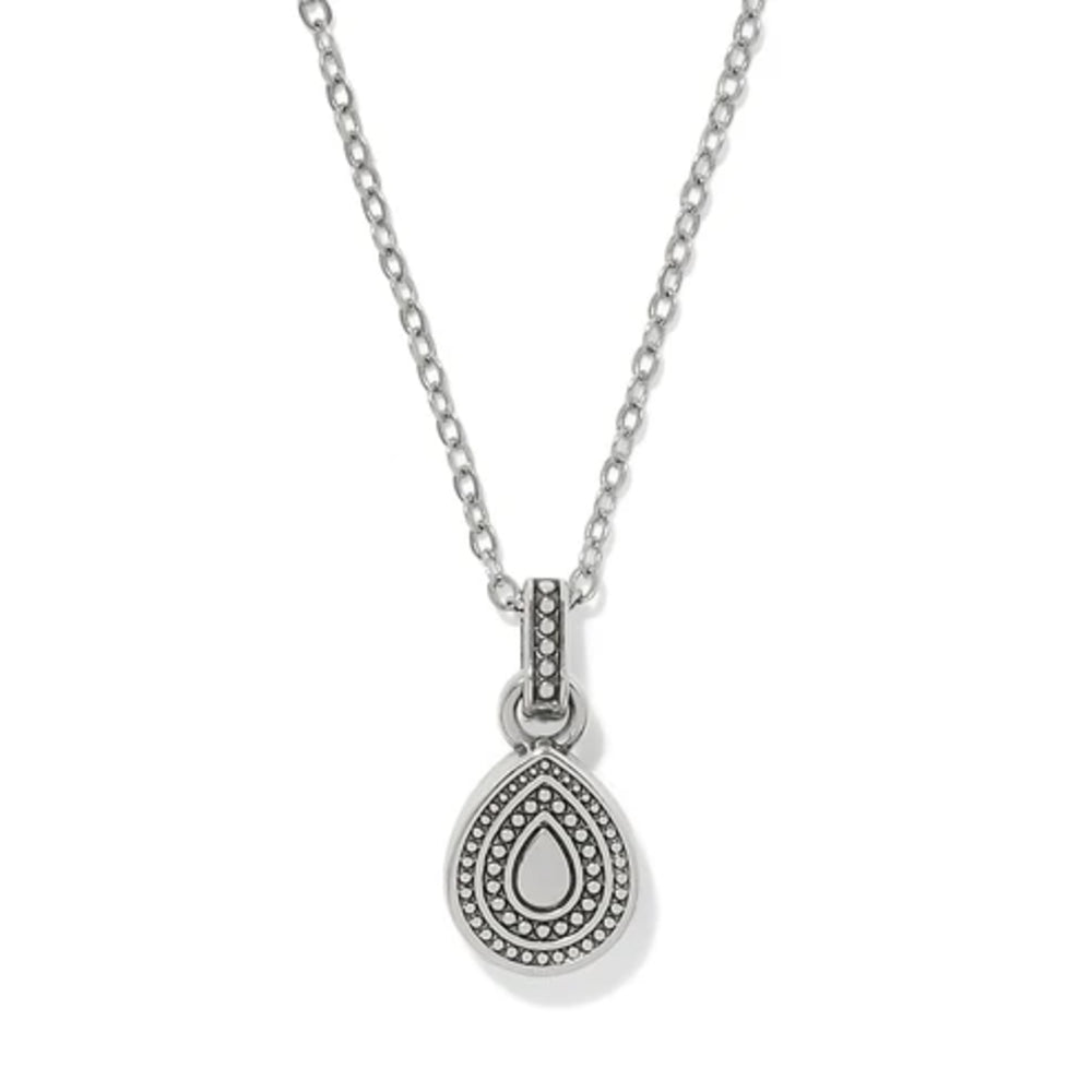 A silver teardrop pendant necklace with a textured beaded border and a central teardrop motif, suspended from a delicate link chain on a white background.