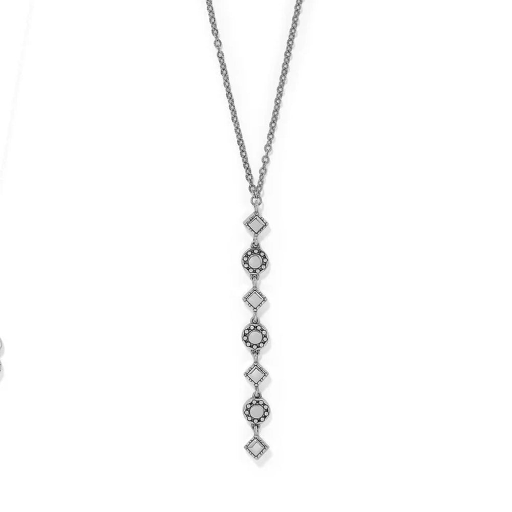 Silver necklace with a long, intricate pendant on a white background