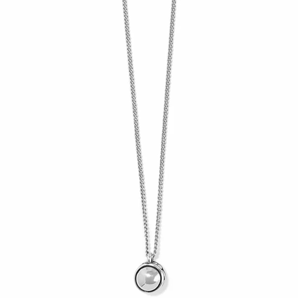 A silver chain necklace with a small circular pendant featuring a faceted clear gemstone, shown against a plain white background.
