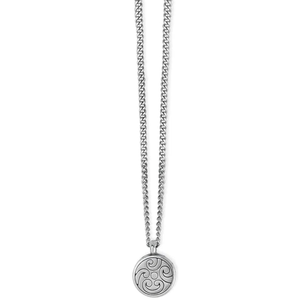 A silver-toned necklace featuring a delicate chain and a circular pendant with an engraved Celtic triskelion symbol, shown against a plain white background.