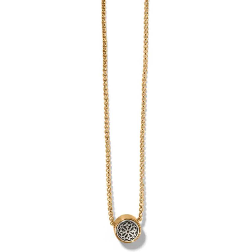 Gold necklace with a round pendant on a white background