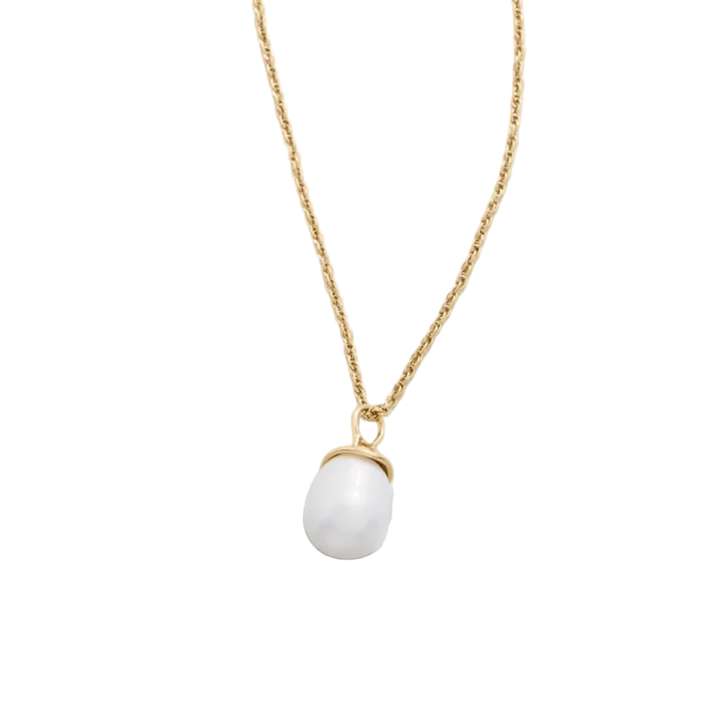 A delicate gold chain necklace featuring a large, smooth white teardrop-shaped pearl pendant held in a gold bezel setting, displayed against a light blue background.