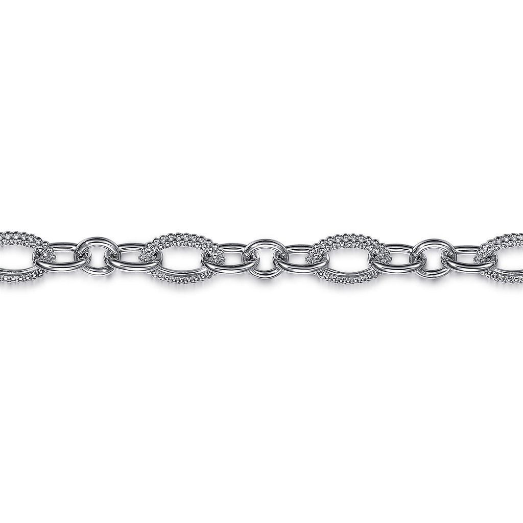 silver round link bracelet on white background