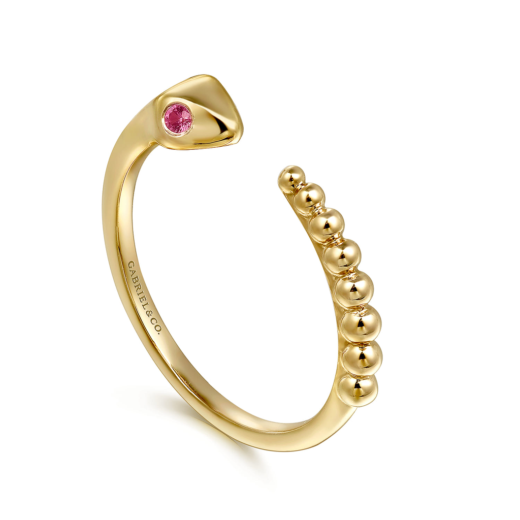 Gold ring with a pink gemstone on a white background