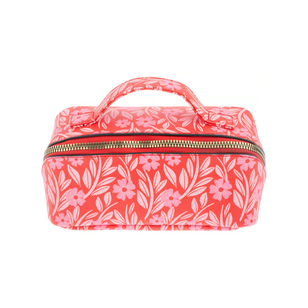 A small rectangular zippered vanity case or cosmetic bag with a top handle, featuring a coral pink and white floral and leaf pattern, photographed on a solid white background.