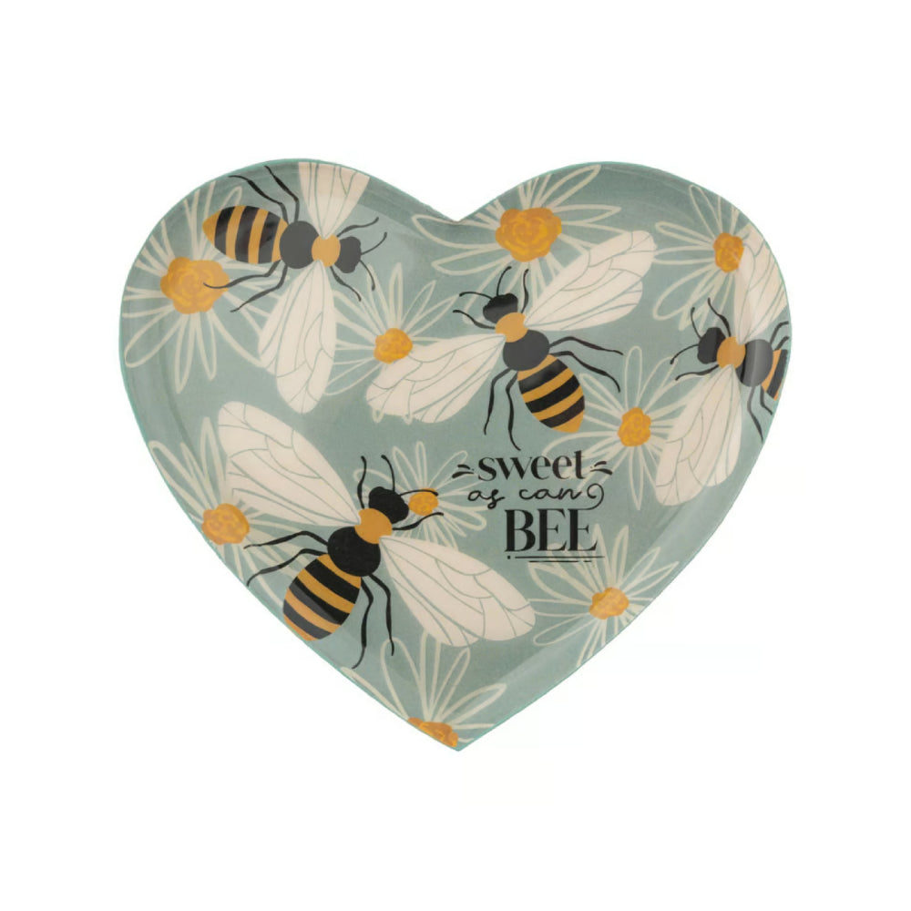 A heart-shaped decorative plate featuring a pattern of bumblebees, daisies, and the text 'sweet as can BEE' on a muted sage green background.