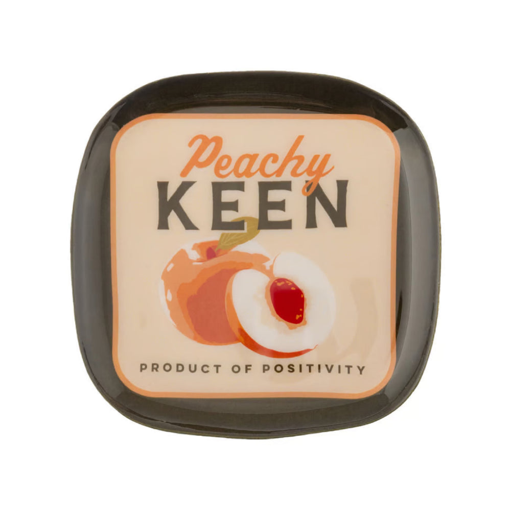 A square metal tray with rounded corners, featuring a peach-themed label that reads 'Peachy KEEN' and 'PRODUCT OF POSITIVITY' with an illustration of a peach and peach slice.