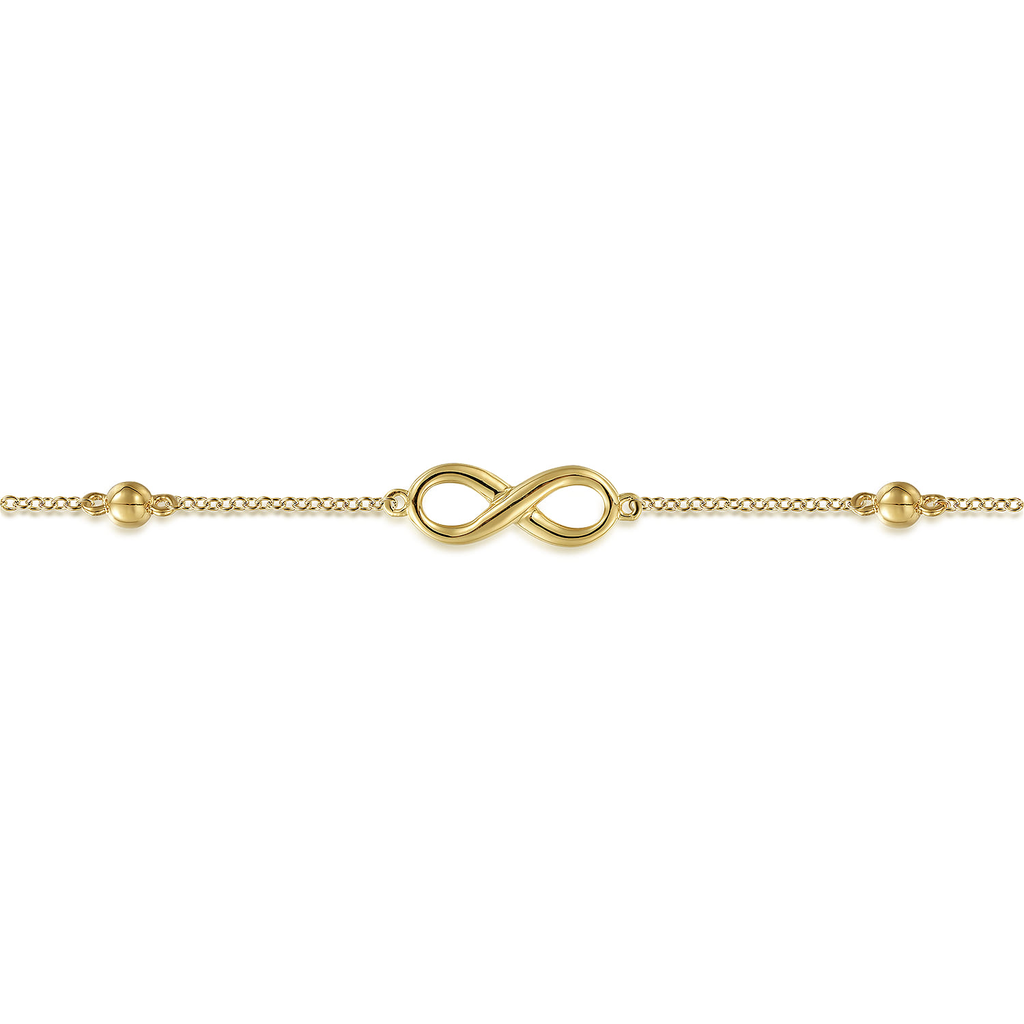 gold infinity symbol bracelet on a white background