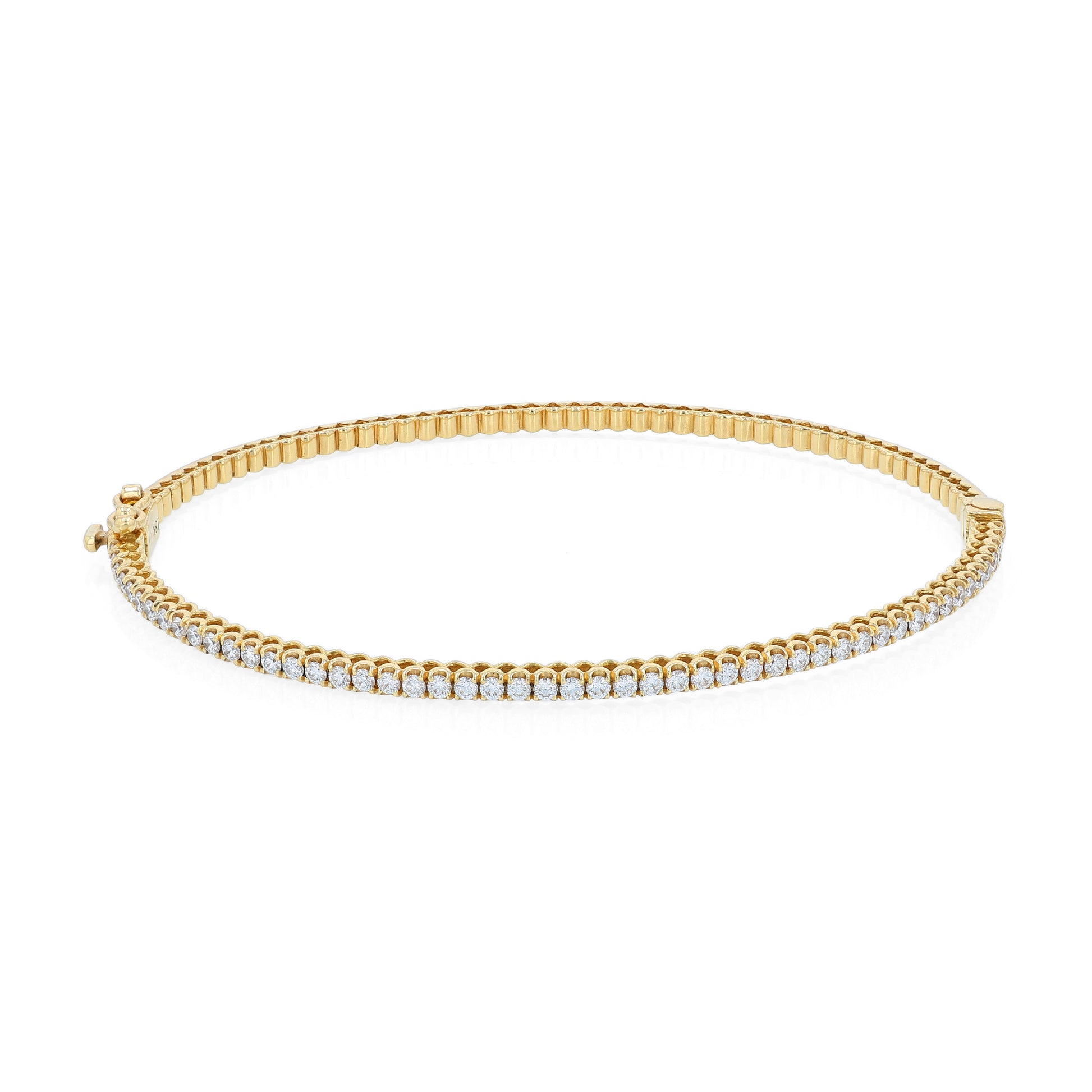 Thin yellow gold bracelet with diamonds on a white background