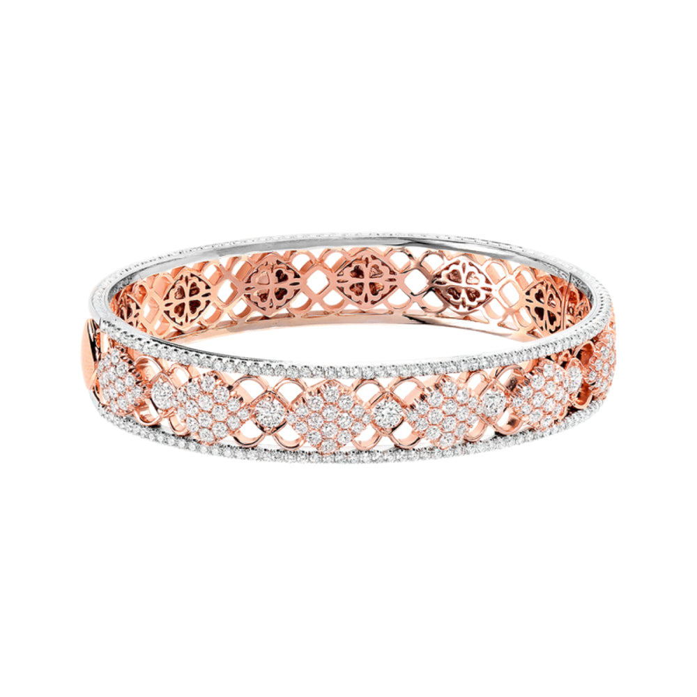 Two-tone gold bracelet with open work design and diamond accents on a white background