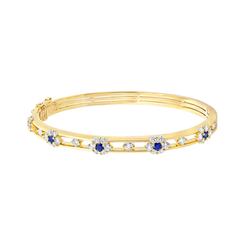 Yellow gold bracelet with diamond and blue sapphire accents on a white background