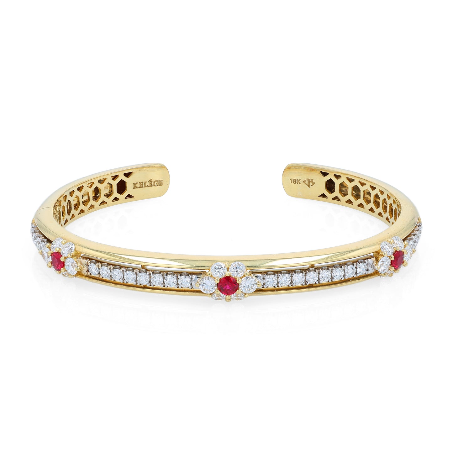 Yellow gold bracelet with diamond and ruby accents on a white background