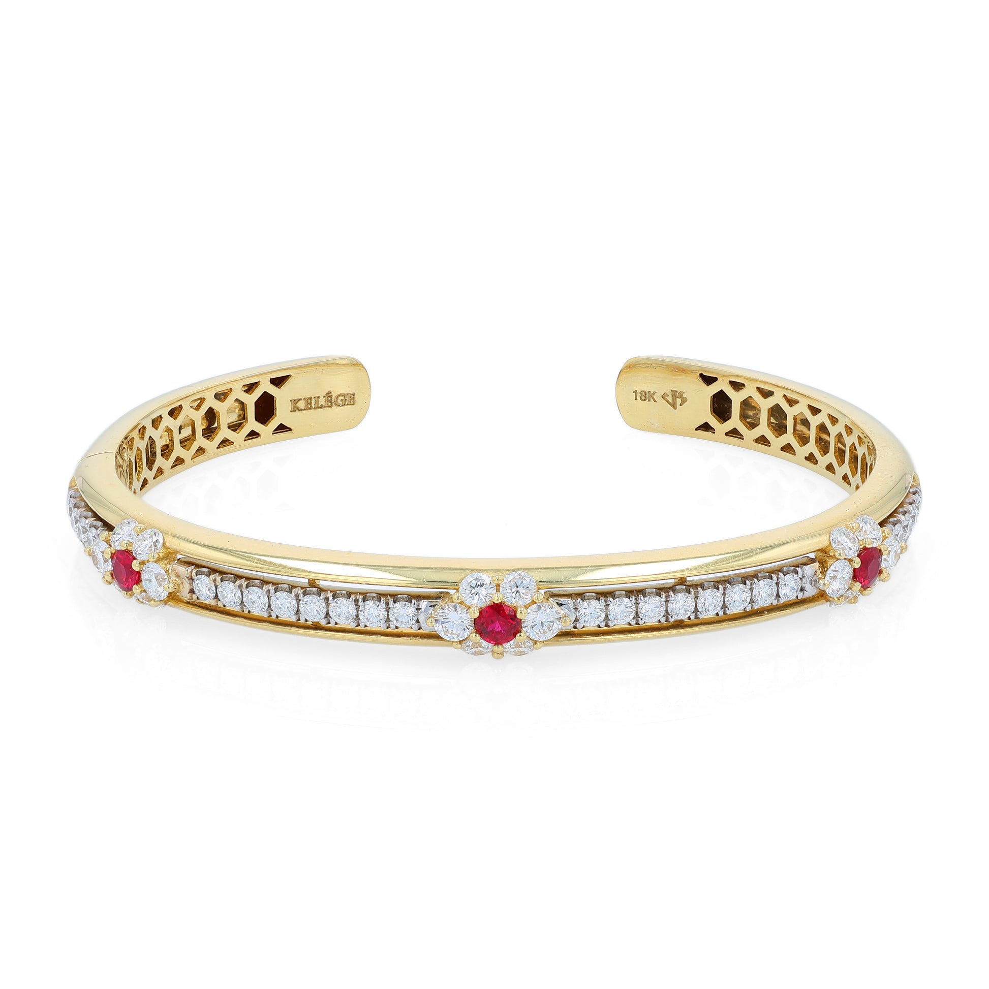 Yellow gold bracelet with diamond and ruby accents on a white background
