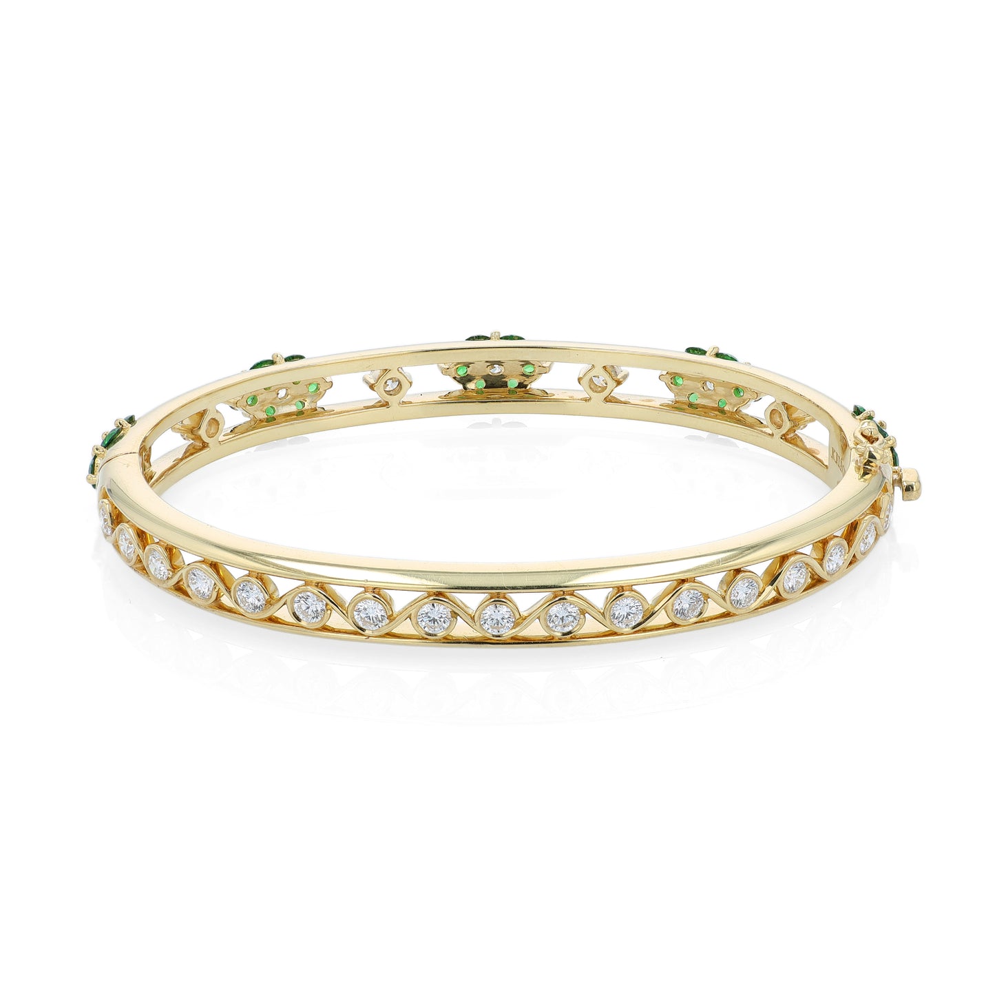 Yellow gold bracelet with green tsavorites and diamond accents on a white background